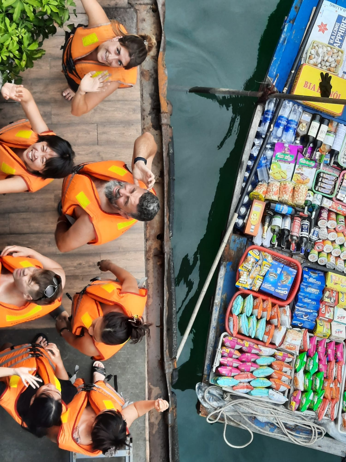 A group of people in orange life jackets Description automatically generated